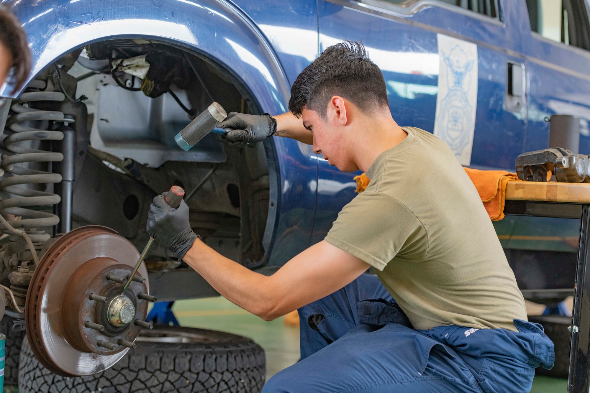 Airman 1st Class Deal Torre Joseph, 374th Logistics Readiness Squadron Vehicle Maintenance Flight apprentice, removes a brake rotor from a truck used by the 374th Security Forces Squadron at Yokota Air Base, Japan, Aug. 17, 2022.