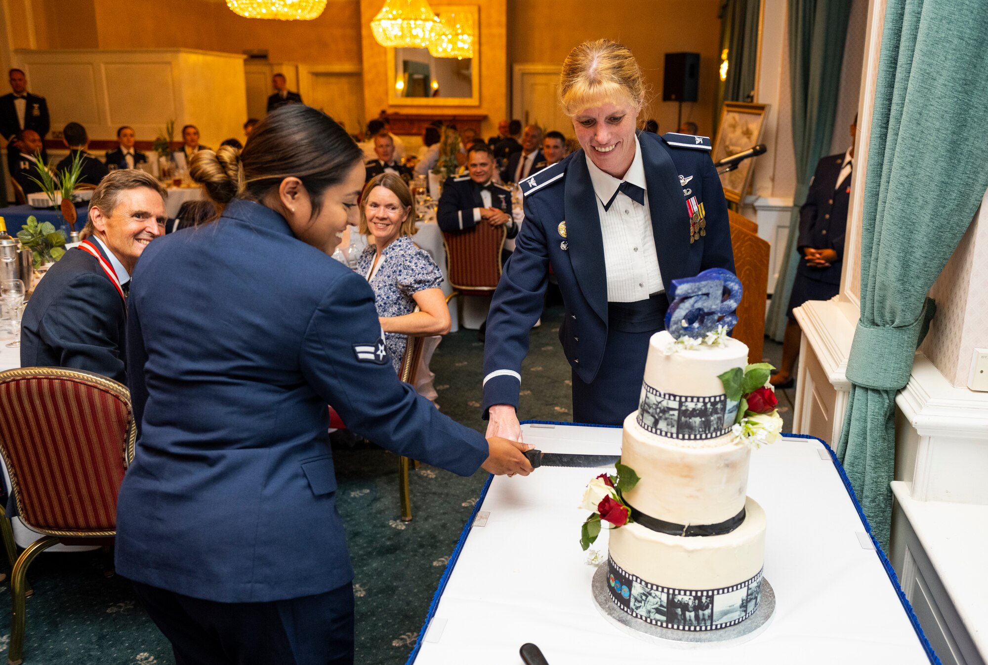 U.S. Air Force Col. Kristin Thompson, 55th Wing commander, right, and Airman 1st Class Noelia Alvarez-Mendoza, 95th Reconnaissance Squadron aviation resource manager, cut the cake during the 95th RS’s 105th anniversary celebration at Royal Air Force Mildenhall, England, Aug. 19, 2022. The 95th RS is a component unit of the 55th Operations Group at Offut Air Force Base, Nebraska, though they are currently assigned to RAF Mildenhall to conduct information gathering flight operations throughout the European and Mediterranean theaters.