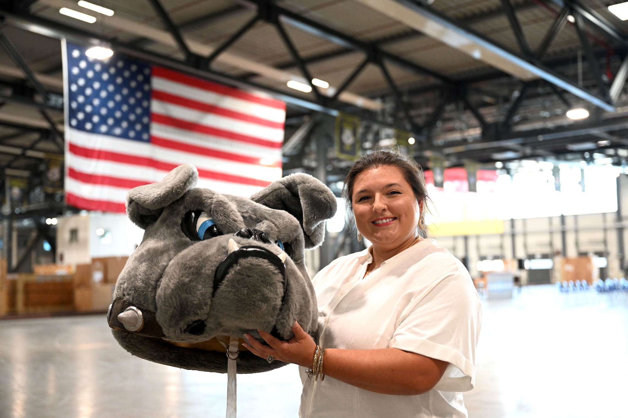 Chelsie Moncecchi, Key Spouse, poses for a photo with the 721st Aerial Port Squadron Port Dawg mascot on Ramstein Air Base, Germany, Aug. 5, 2022. Moncecchi won U.S. Air Force Key Spouse of the Year for her service as a 721st APS Key Spouse from January to December 2021 and was with the unit's program for four years.