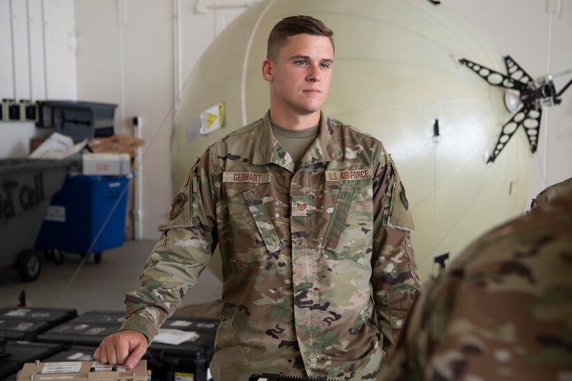 Staff Sgt. William Gerhart, 193rd Special Operations Squadron cyber transport technician, stands at his station during a career fair in Middletown, Pa., August 6, 2022. The wing hosted the career fair to allow Airmen to see different career fields and learn about their capabilities in hopes of cultivating a community atmosphere.