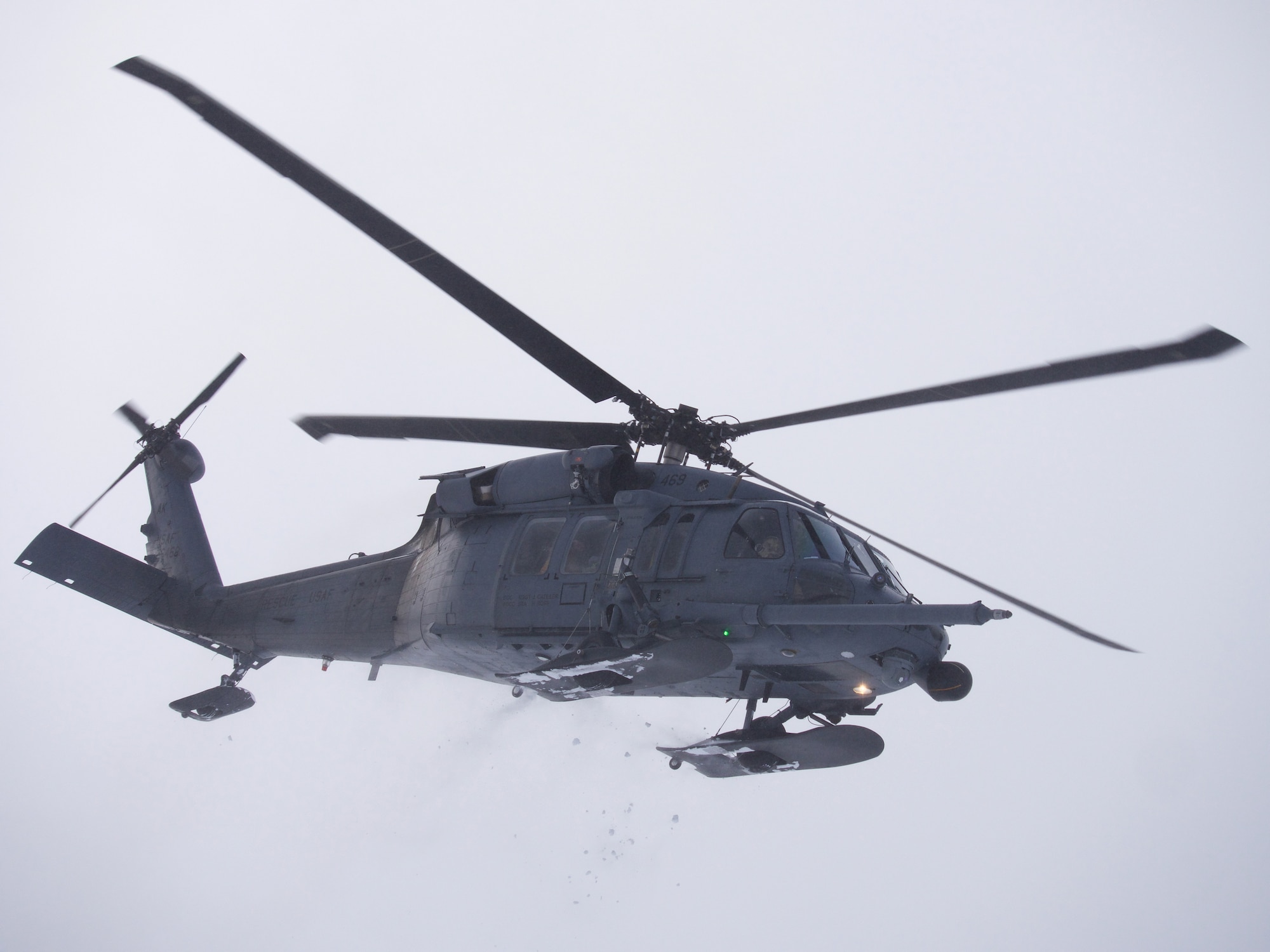 An Alaska Air National Guard 210th Rescue Squadron HH-60G Pave Hawk helicopter transits Joint Base Elmendorf-Richardson's Malamute Drop Zone Feb. 10, 2021, during parachute jump operations.