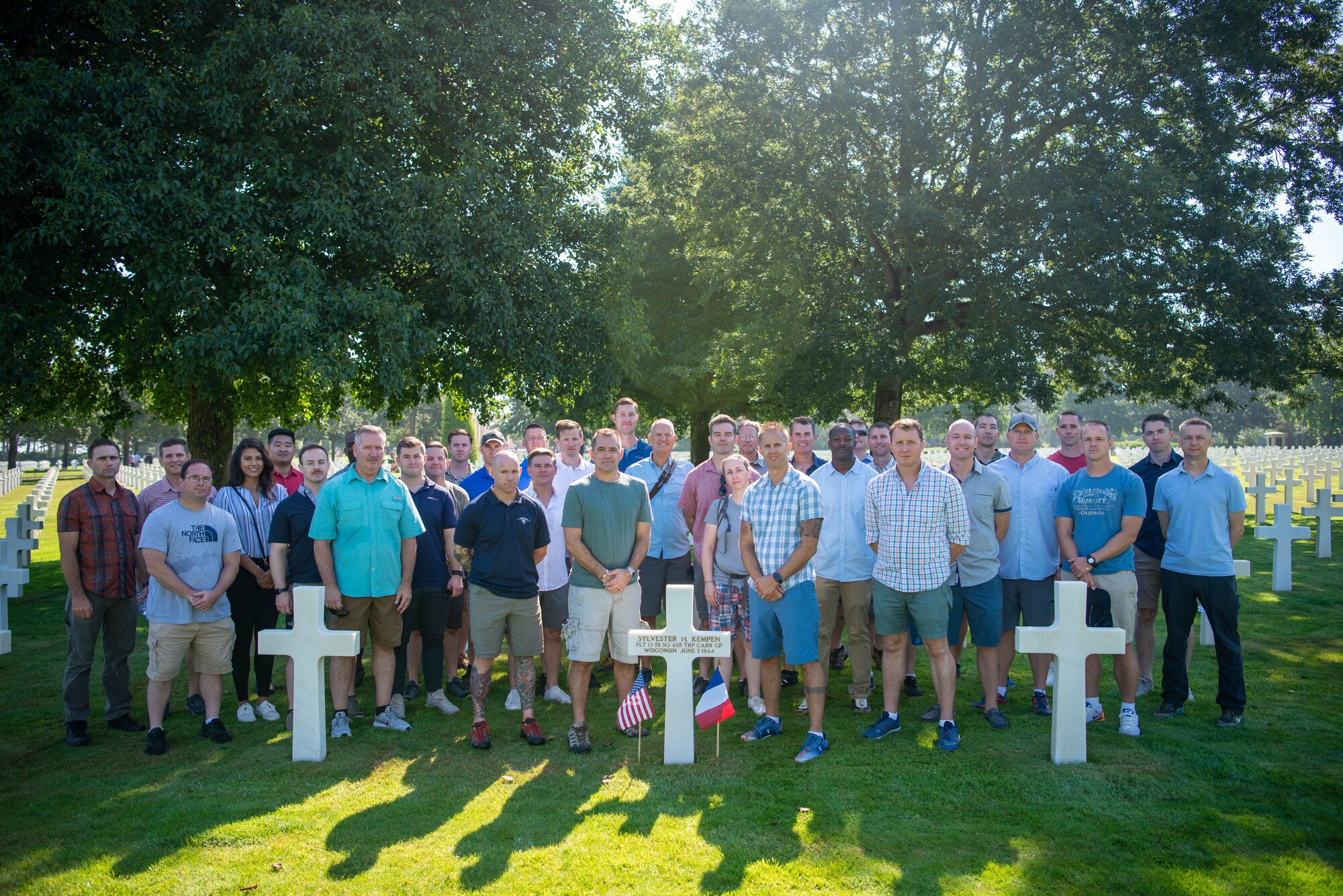 people stand around cross