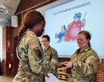 Capt. Shaneka Ashman, operations officer for the 143rd Regional Support Group, receives a certificate of completion for the Military Reserve Exchange Program at Camp Nymindegab in Denmark around July 8, 2022.