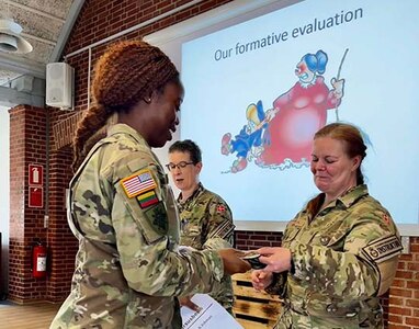 Capt. Shaneka Ashman, operations officer for the 143rd Regional Support Group, receives a certificate of completion for the Military Reserve Exchange Program at Camp Nymindegab in Denmark around July 8, 2022.