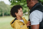 A child hugs his father