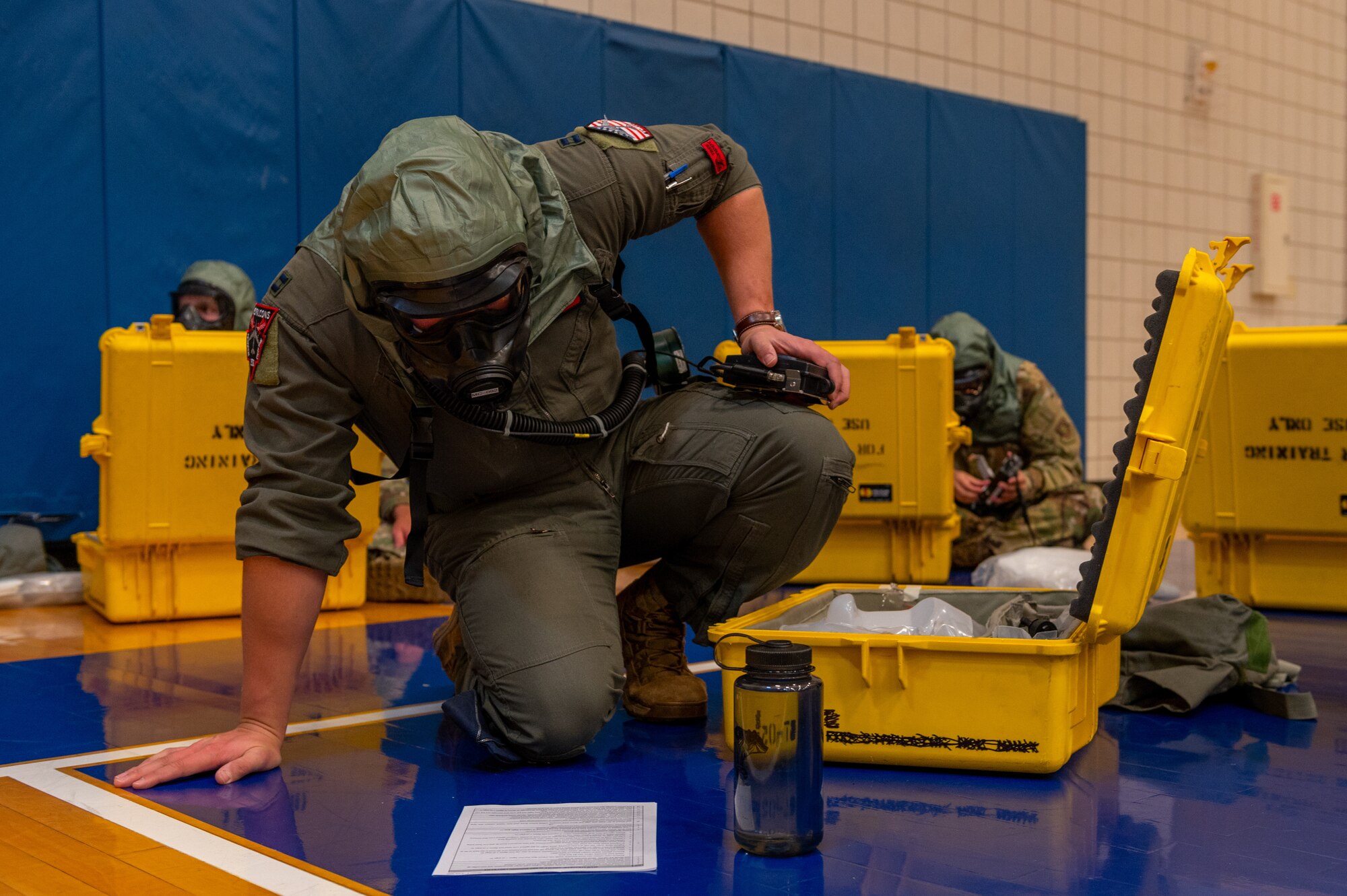 Captain Matthew Greco, 350th Air Refueling Squadron co-pilot, reviews instructions for dawning Aircrew Eyes and Respiratory Protection Equipment Aug. 19, 2022, at McConnell Air Force Base, Kansas. Airmen from the 350th ARS worked with the 22nd Operation Support Squadron’s aircrew flight equipment team on Aircrew Chemical Control Area processes and procedures. (U.S. Air Force photo by Airman 1st Class Brenden Beezley)