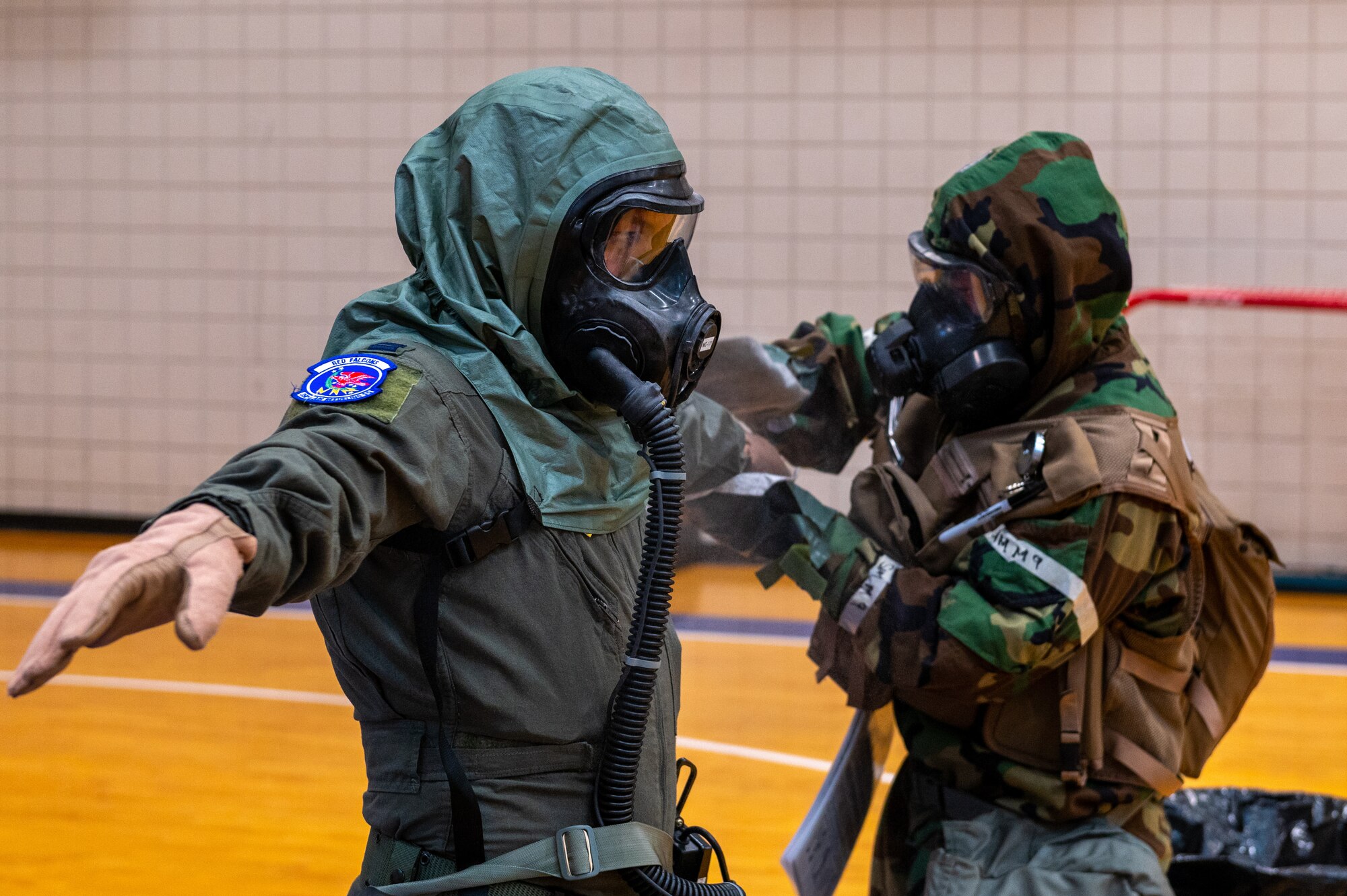 Airman 1st Class Tub Vang, 22nd Operation Support Squadron aircrew flight equipment technician, practices decontamination procedures on Capt. Andy Nguyen, 350th Air Refueling Squadron copilot, Aug. 19, 2022, at McConnell Air Force Base, Kansas. The 350th ARS worked with the 22nd OSS AFE team on Aircrew Chemical Control Area processes and procedures. (U.S. Air Force photo by Airman 1st Class Brenden Beezley)