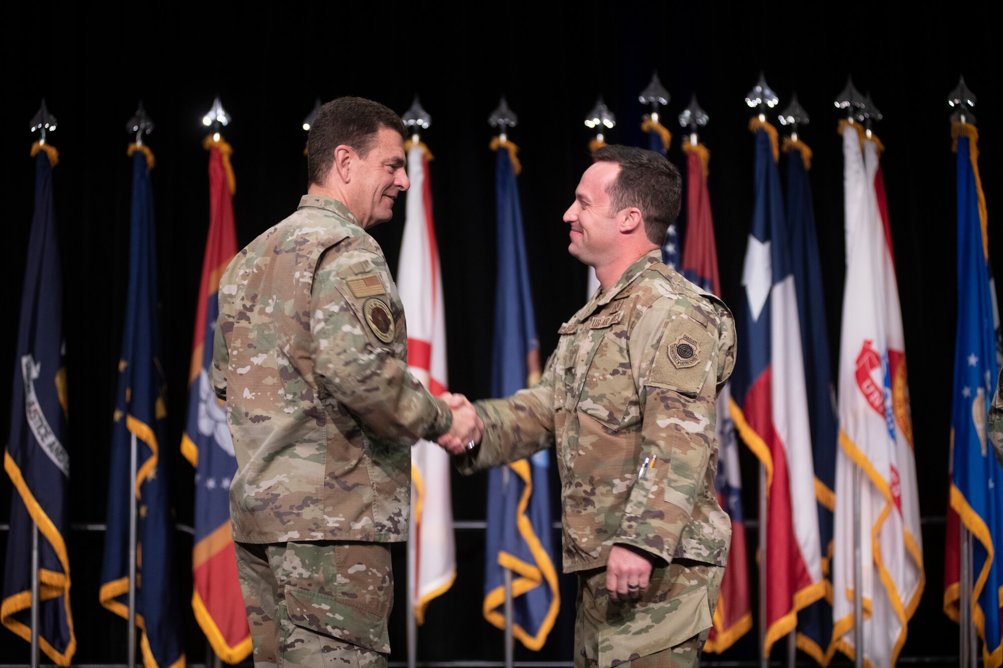 U.S. Air Force Lt. Gen. Michael A. Loh, director, Air National Guard (ANG), shakes hands Master Sgt. Daniel Keller, 124th Fighter Wing, Idaho National Guard, during an Outstanding Airmen of the Year (OAY) recognition ceremony at the 2022 Air National Guard Senior Leader Conference (ASLC) in Dallas, Texas, April 20, 2022. Loh and Command Chief Master Sgt. Maurice L. Williams, command chief, ANG, recognized three of ANG’s OAY winners for 2021 for their superior leadership, job performance and overall excellence. (U.S. Air National Guard photo by Tech. Sgt. Morgan R. Whitehouse)