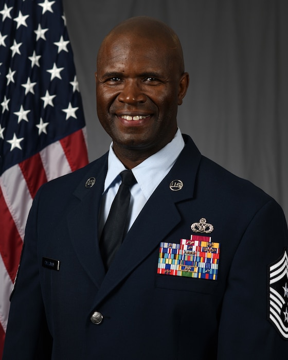 Man in uniform smiles at camera