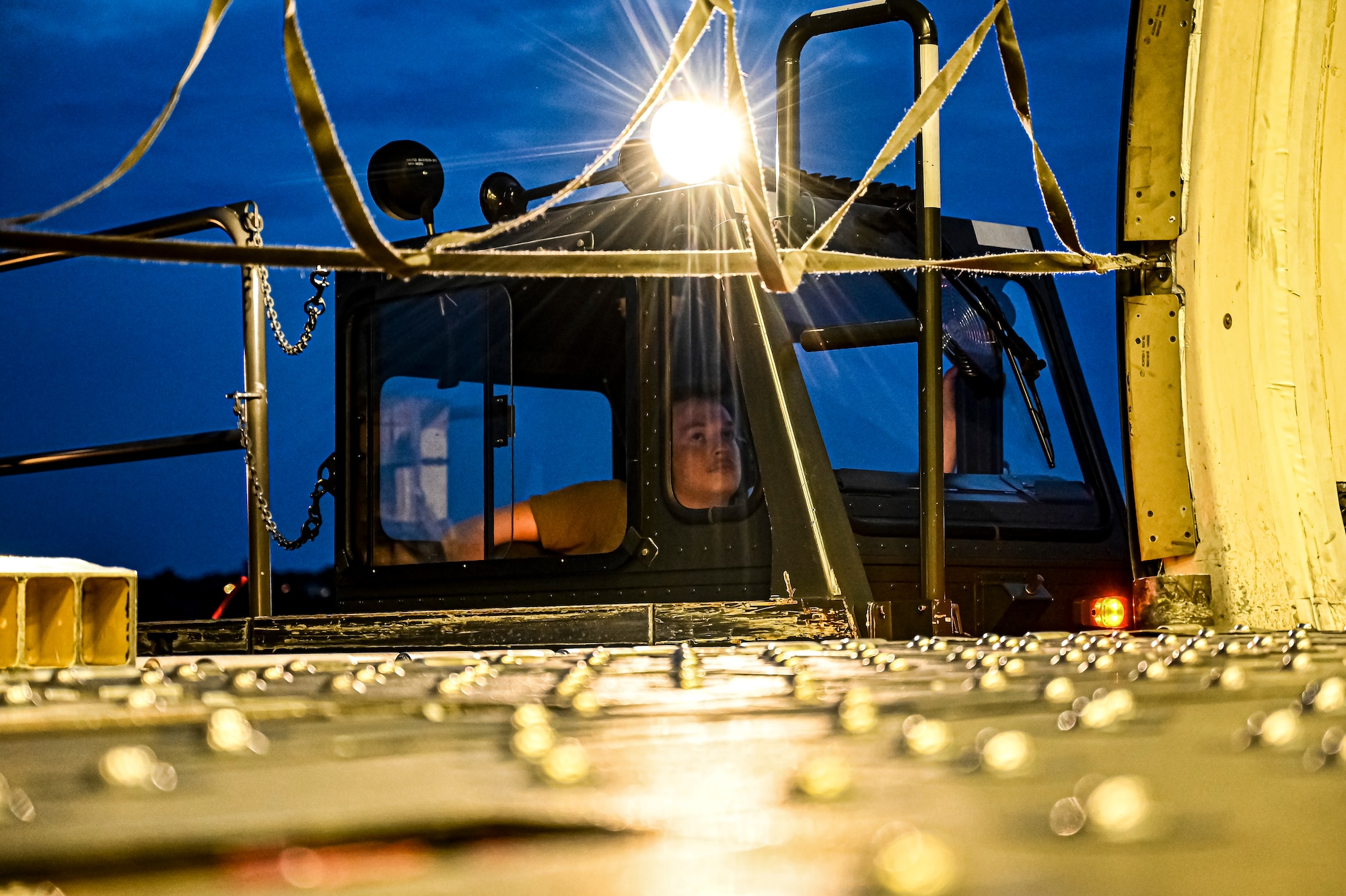 An Airman assigned to the 305th Aerial Port Squadron air transportation, drives a K loader to upload Guided Multiple Launch Rocket System munitions at Joint Base McGuire-Dix-Lakehurst, N.J., Aug. 11, 2022. The munitions cargo is part of an additional security assistance package for Ukraine. The security assistance the U.S. is providing to Ukraine is enabling critical success on the battlefield against the Russian invading force. (U.S. Air Force photo by Senior Airman Matt Porter)