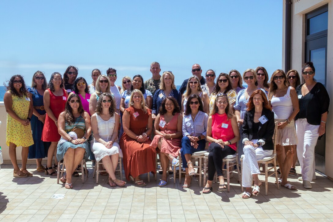 Spouses of senior military members and U.S. Marine Corps Brig. Gen. Woodworth, the commanding general for Marine Corps Installations West, Marine Corps Base Camp Pendleton, pose for a group photo at La Casa Del Mar on Camp Pendleton, California, Aug. 18, 2022. The event showcased the resources available to help Marine spouses and their families stationed aboard MCI-West. Resources include but are not limited to Marine Corps Family Advocacy program, United Service Organization and others. There are over 15 different resources available to families and ways to help the communities across the installations. (U.S. Marine Corps photo by Lance Cpl. Straley)