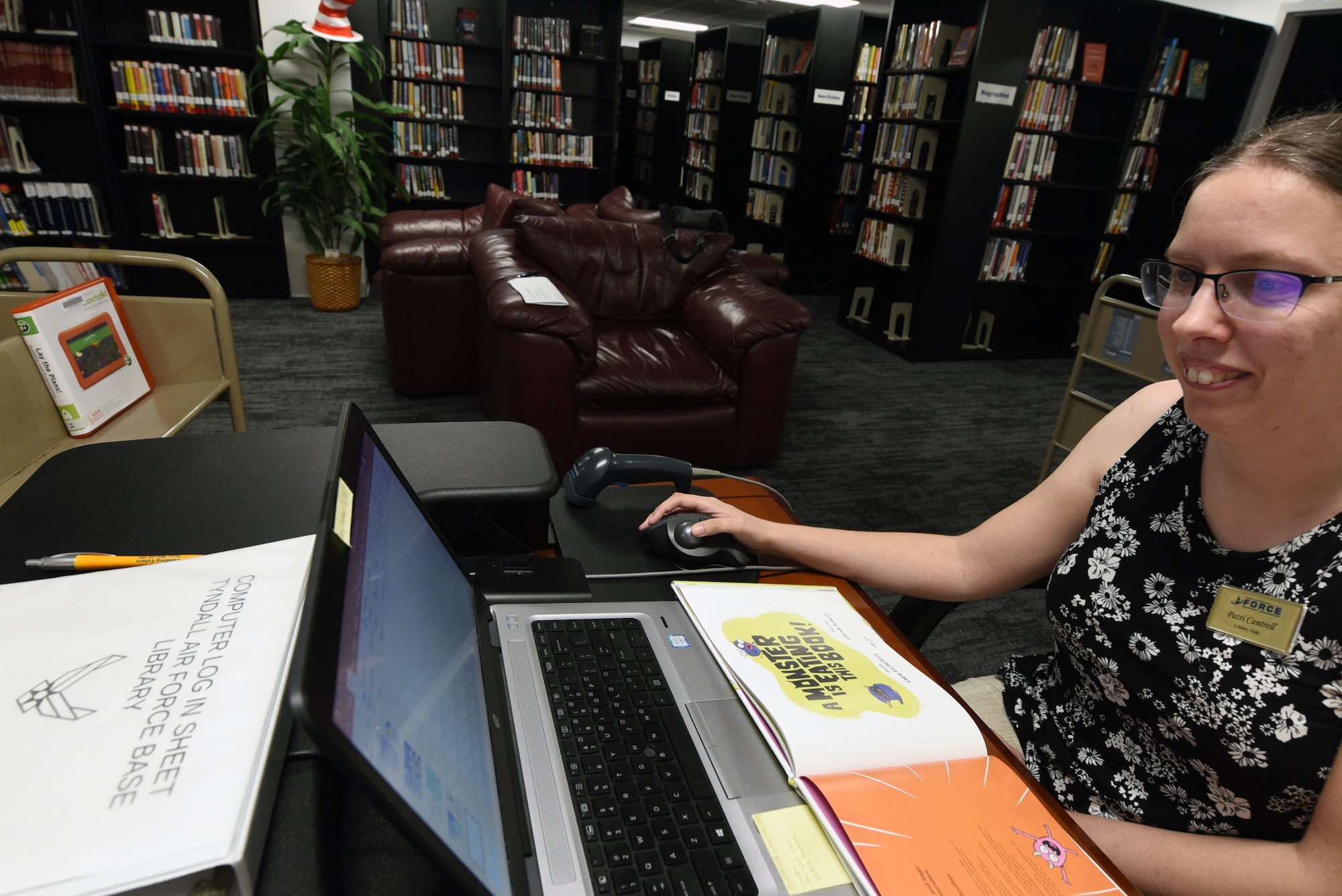 Library staff member works on computer