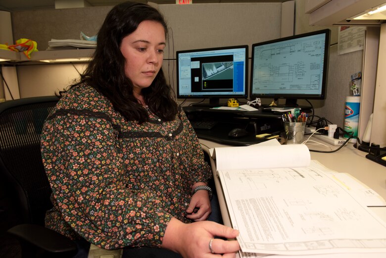 Elizabeth R. Boeglin, civil engineer in the Engineering and Construction Division, is the U.S. Army Corps of Engineers Nashville District Employee of the Month for June 2022. She is being lauded for plan development and design work in support of the Wolf Creek Dam Dissolved Oxygen Project. She is seen here working on plans and specifications Aug. 23, 2022, at the Nashville District Headquarters in Nashville, Tennessee. (USACE Photo by Lee Roberts)