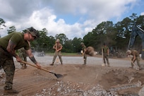 CAMP SHELBY, Miss. (Jul. 20, 2022) Seabees assigned to Naval Mobile Construction Battalion (NMCB) 1 work together with Marines assigned to Marine Wing Support Squadron (MWSS) 273 on repairing the damaged airfield during the airfield damage repair exercise during Operation Turning Point, also known as their Field Training Exercise.