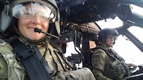 Chief Warrant Officer 4 Kayce Clark pilots a helicopter