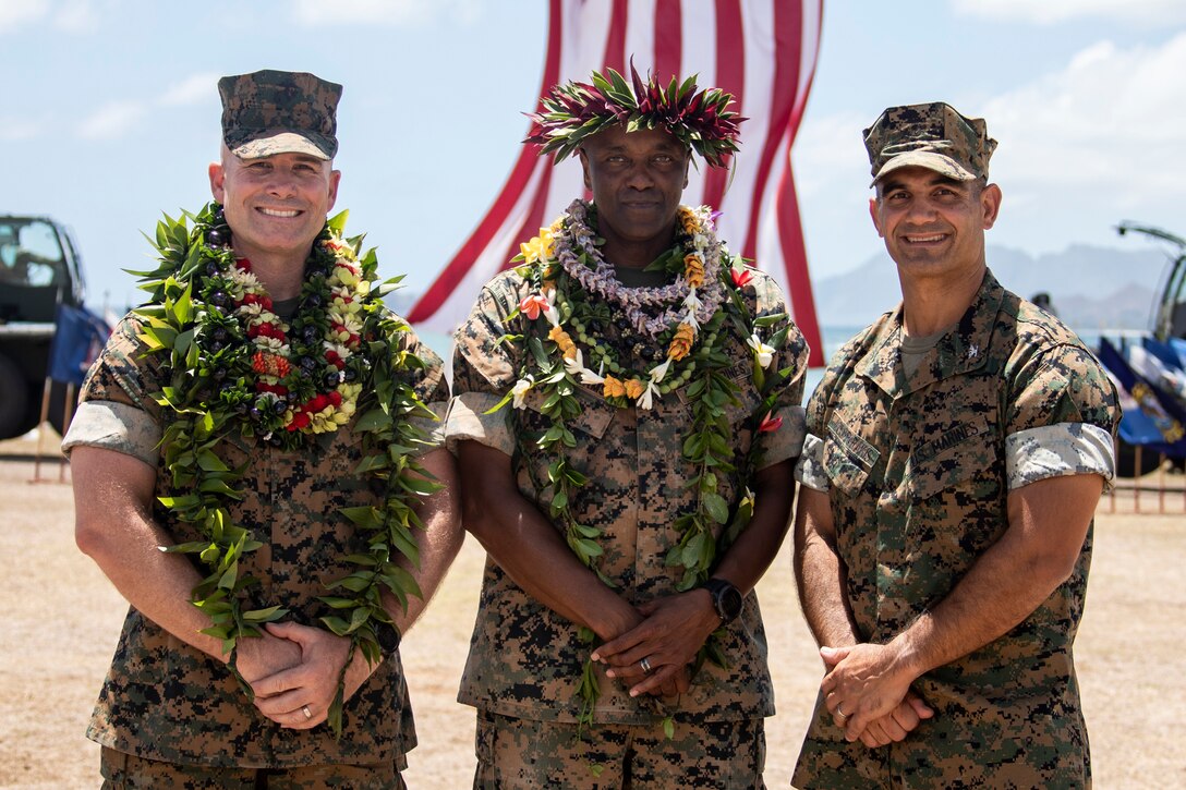 U.S. Marine Corps Sgt. Maj. Lester L. Williams, center, offgoing sergeant major, Marine Corps Base Hawaii, poses for a photo with Col. Speros Koumparakis, right, commanding officer, MCBH, and Sgt. Maj. Joseph J, Caputo, left, oncoming sergeant major, MCBH, during the MCBH Relief and Appointment and Retirement ceremony, MCBH, Aug. 19, 2022. Williams was relieved by Caputo as the MCBH Sergeant Major. Williams served over 30 years in the U.S. Marine Corps. (U.S. Marine Corps photo by Cpl. Samantha Sanchez)
