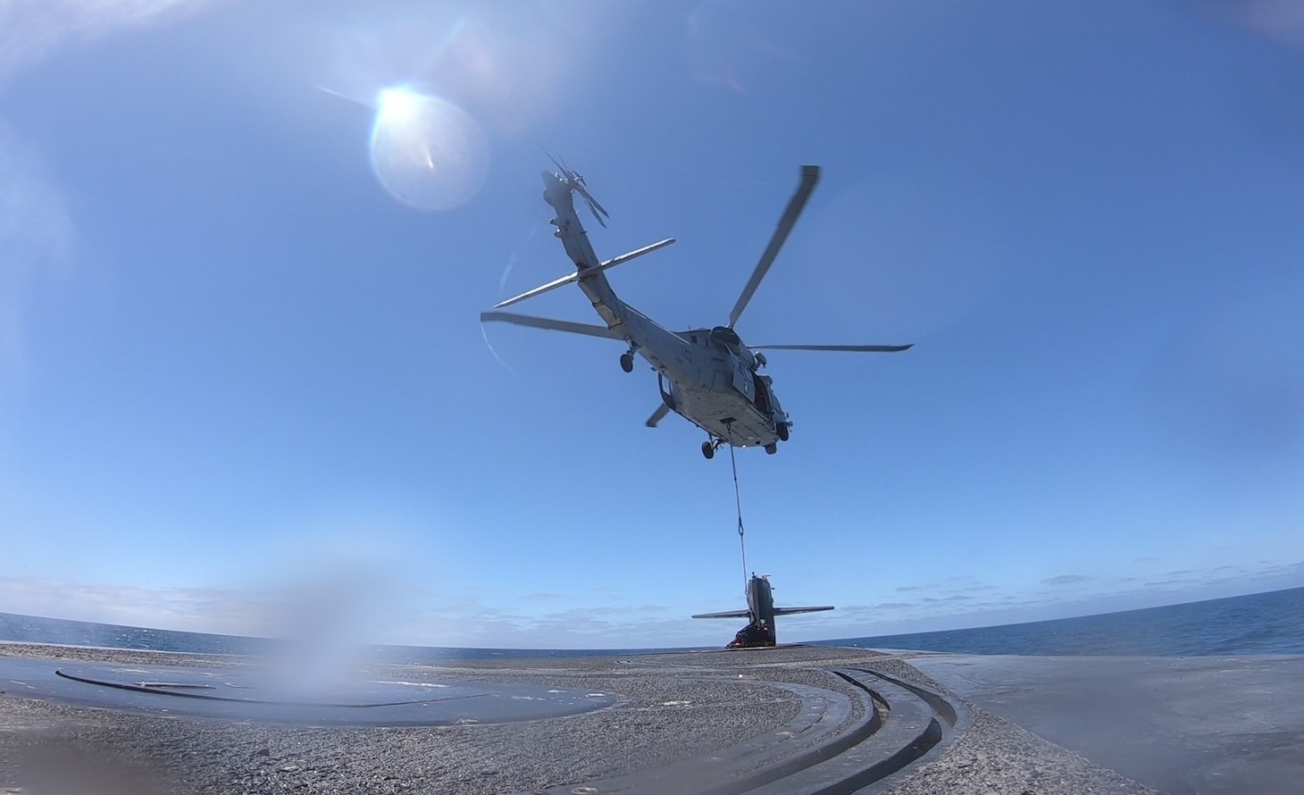 PACIFIC OCEAN (July 7, 2022) An MH-60R Seahawk helicopter, assigned to the “Wildcats” of Helicopter Sea Combat Squadron 23, delivers supplies to the ballistic missile submarine USS Nevada (SSBN 733) during a vertical replenishment at sea. Alabama is one of eight ballistic-missile submarines stationed at Naval Base Kitsap-Bangor, providing the most survivable leg of the strategic deterrence triad for the United States. (U.S. Navy photo)