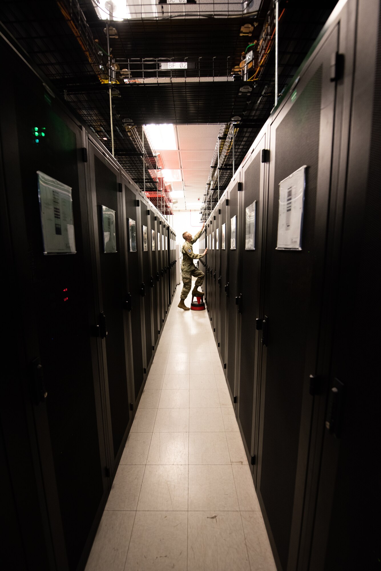 U.S. Space Force Sgt. Kelcey Fisher, 21st Communications Squadron circuit actions technician, conducts an inspection on communication systems inside a server room on Peterson Space Force Base, Colorado, Aug. 12, 2022.