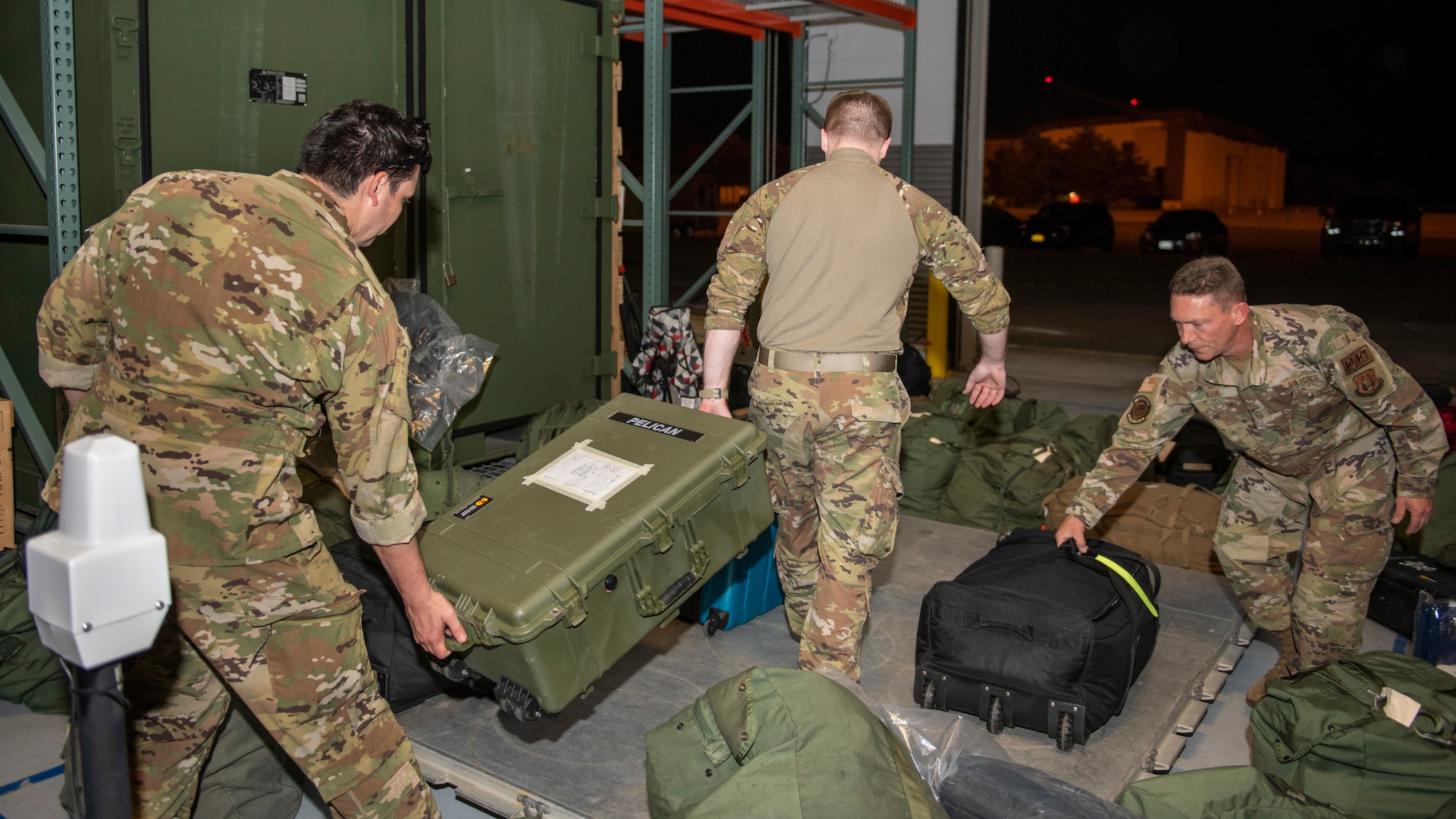 Reserve Citizen Airmen from the 46th and 71st aerial port squadrons, 512th Airlift Wing, Dover Air Force Base, Del., load cargo onto a pallet Aug. 14, 2022. The aerial porters and their palletized cargo flew aboard a C-17 Globemaster III to a Joint Readiness Training Center exercise at Fort Polk, La. JRTC scenarios allow complete integration of Air Force and other military services as well as host-nation and civilian role players. The exercises replicate many of the unique situations and challenges a unit may face including host-national officials and citizens, insurgents and terrorists, news media coverage, and non-governmental organizations. (U.S. Air Force photos by Senior Airman Ruben Rios)