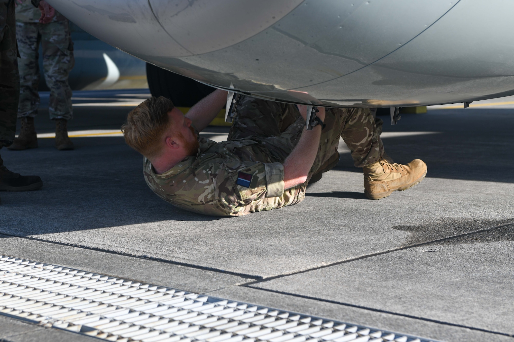 RAF aviator performs routine maintenance on an aircraft.