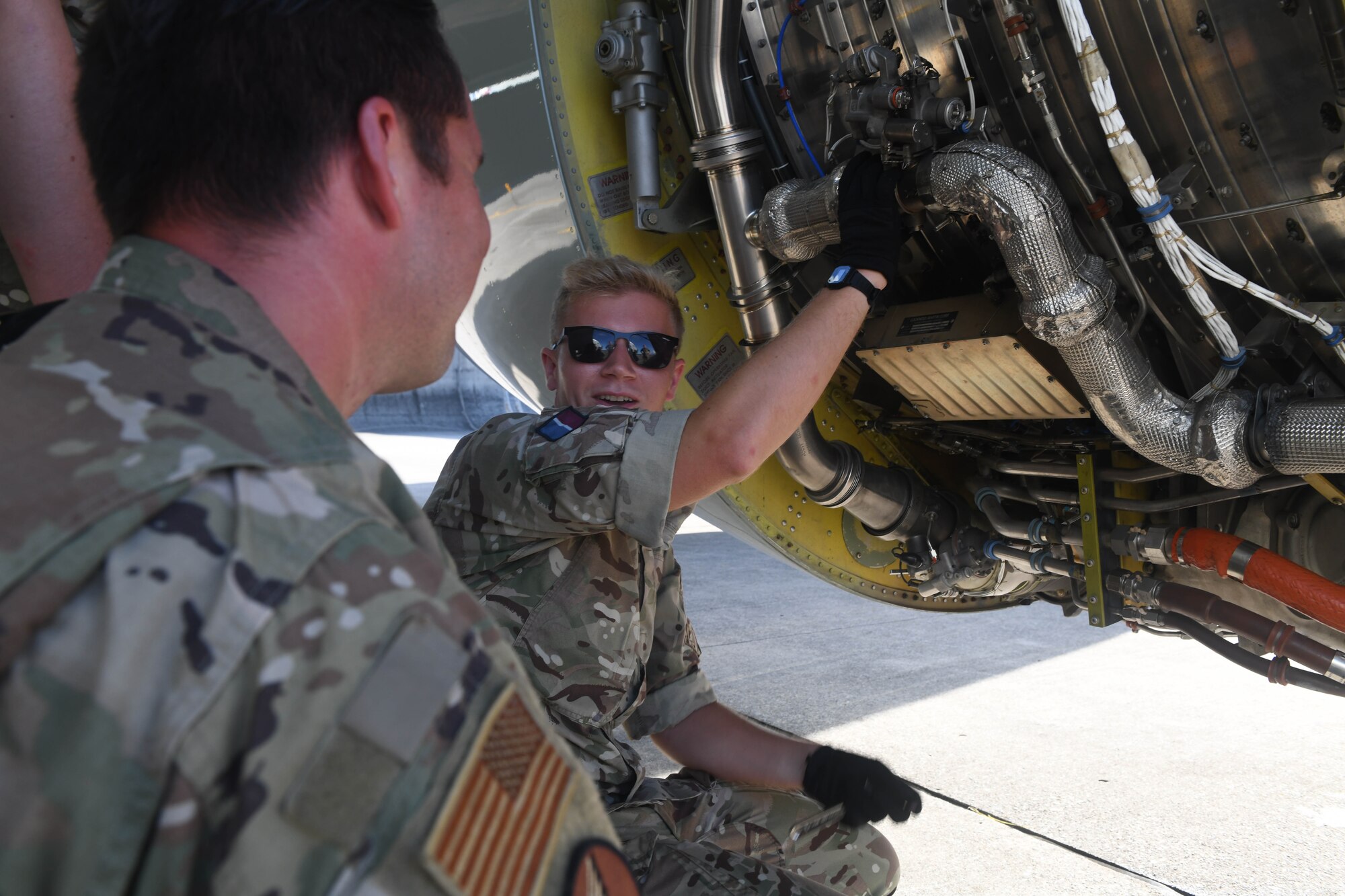 Airman and aviator work together on an aircraft.