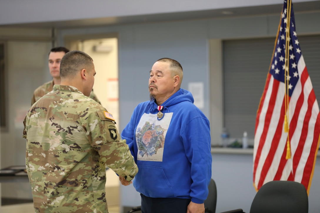 Alaska Army Guard Maj. Walter Hotch-Hill, 49th Missile Defense Battalion (Ground-based Midcourse Defense), shakes Sgt. 1st Class Joseph Sallaffie’s, 1st Battalion, 297th Infantry Regiment, hand after presenting him with the Meritorious Service Medal during a retirement ceremony at the National Guard armory in Bethel, Aug. 19, 2022.