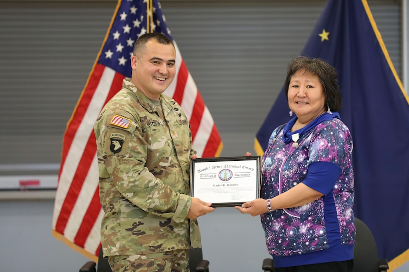 Alaska Army Guard Maj. Walter Hotch-Hill, 49th Missile Defense Battalion (Ground-based Midcourse Defense), presents Rachel Sallaffie with a certificate of appreciation for her support to the organization during a retirement ceremony for her husband, Sgt. 1st Class Joseph Sallaffie, at the National Guard armory in Bethel, Aug. 19, 2022.