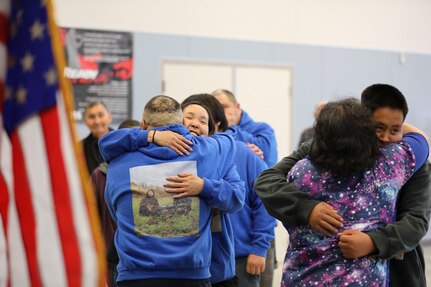 Rachel Sallaffie, right, and her husband, Sgt. 1st Class Joseph Sallaffie, left, hug family and friends as they pass through a receiving line following a retirement ceremony at the National Guard armory in Bethel, Aug. 19, 2022.