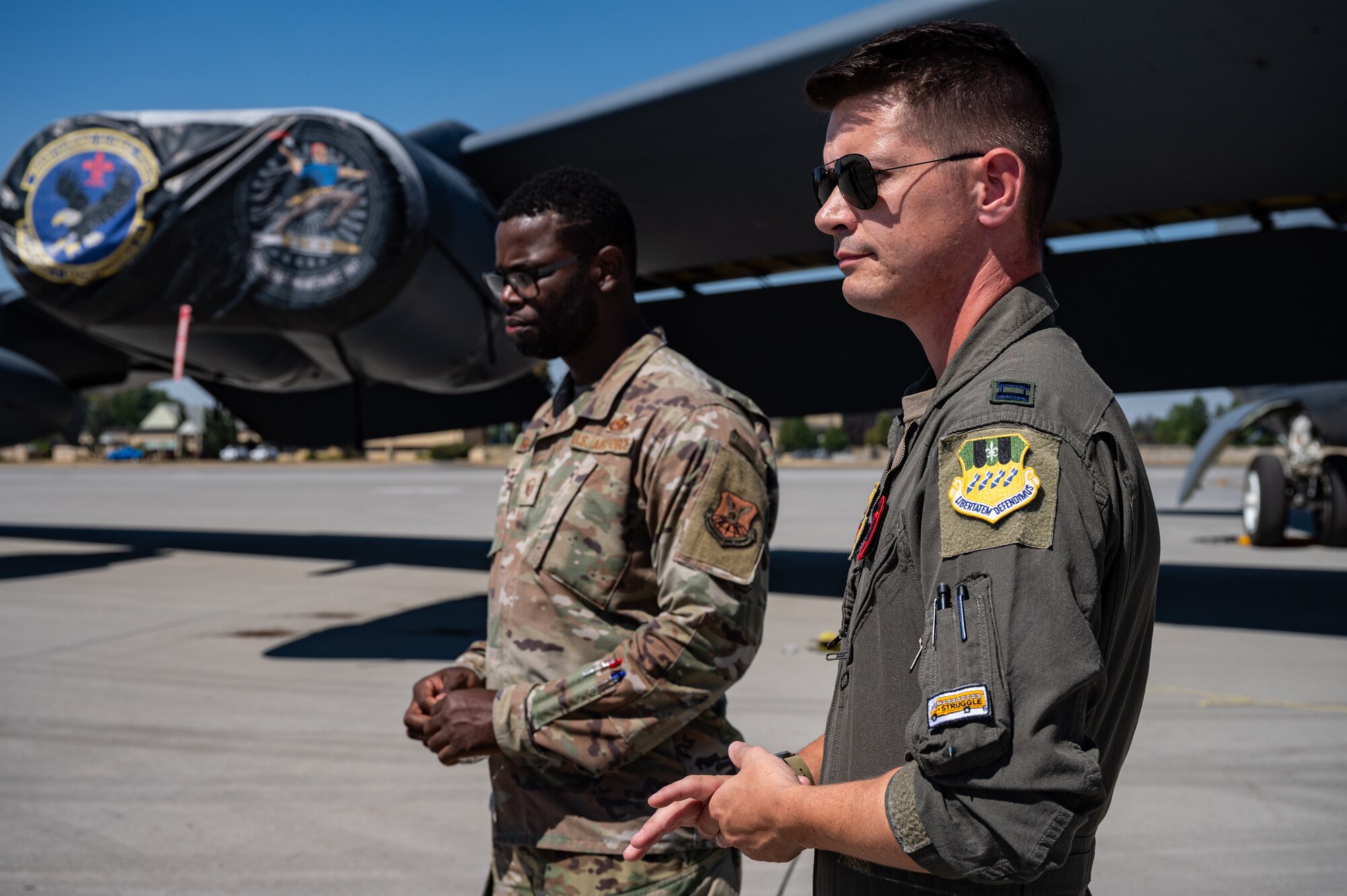 Capt. Tanner Devotie, right, 96th Bomb Squadron aircraft commander, and Master Sgt. Anthony Williams Jr., left, 2nd Aircraft Maintenance Squadron production superintendent, speak with local news media before an interview at Fairchild Air Force Base, Washington, Aug. 17, 2022. Four separate news media outlets covered the first return of the B-52H Stratofortress to Fairchild in 12 years. (U.S. Air Force photo by Senior Airman Chase Sullivan)(U.S. Air Force photo by Senior Airman Chase Sullivan)