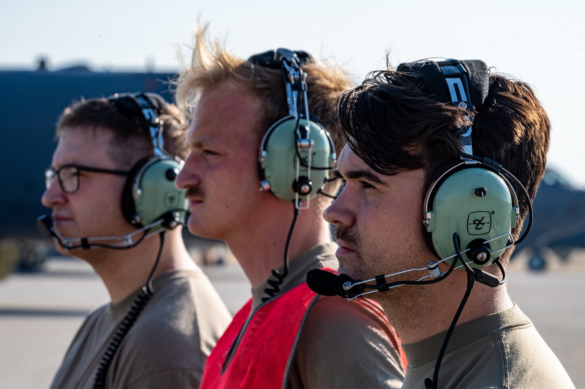 Staff Sgt. Patrick Gault, right,, Airman 1st Class Jacob Kellet, center, and Senior Airman Justin Whitehead, all 2nd Aircraft Maintenance Squadron crew chiefs, communicate with aircrew aboard a B-52H Stratofortress during an Agile Combat Employment exercise at Fairchild Air Force Base, Washington, Aug. 18, 2022. The ACE concept focuses on responsiveness, rapid deployment, versatility and maneuverability to create new strategic options that reduce the risk to Air Force personnel. (U.S. Air Force photo by Senior Airman Chase Sullivan)