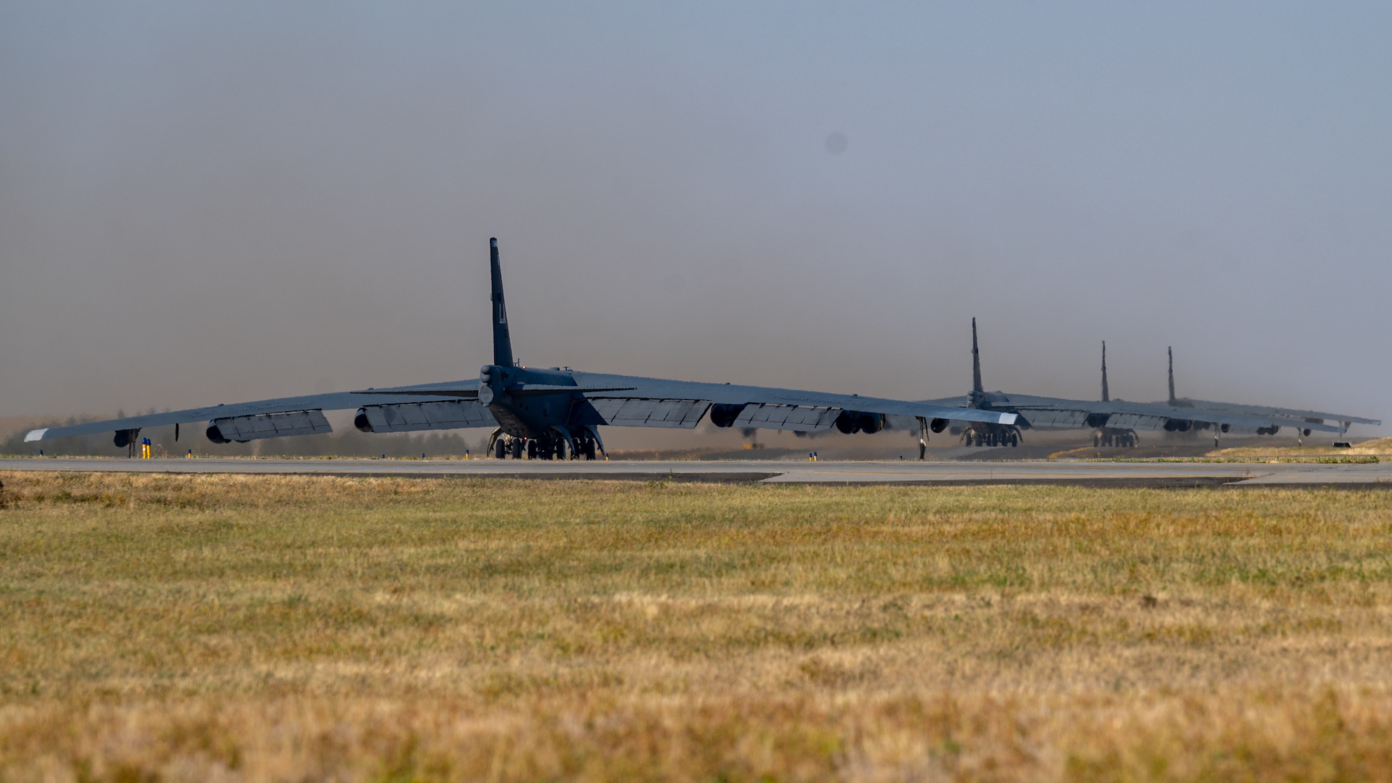 Four B-52H Stratofortresses taxi down the runway during an Agile Combat Employment exercise at Fairchild Air Force Base, Washington, Aug. 18, 2022. This exercise marks the first time the B-52 has operated out of Fairchild since 2010. (U.S. Air Force photo by Senior Airman Chase Sullivan)