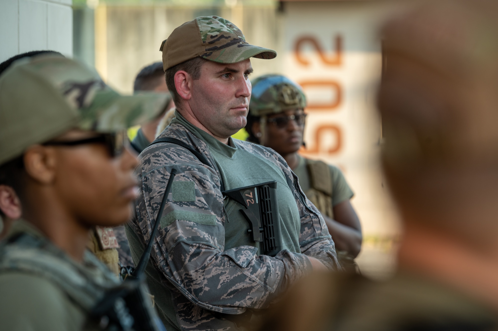 Senior Airman Colton Nygren, 51st Security Forces Squadron member, and other Security Forces Airmen listen during an out-brief following a simulated attack at Osan Air Base