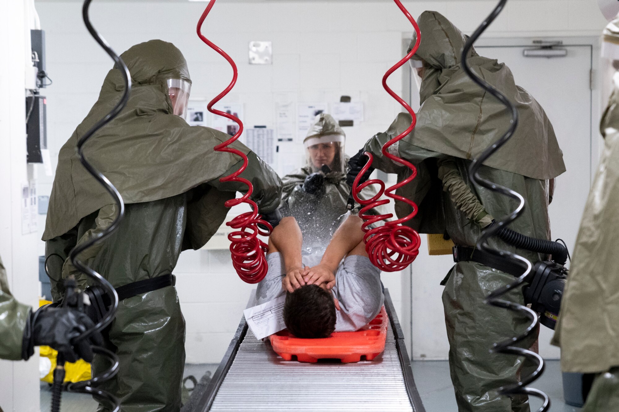 Airmen assigned to the 51st Medical Group decontaminate a simulated patient as part of a base-wide training event at Osan Air Base