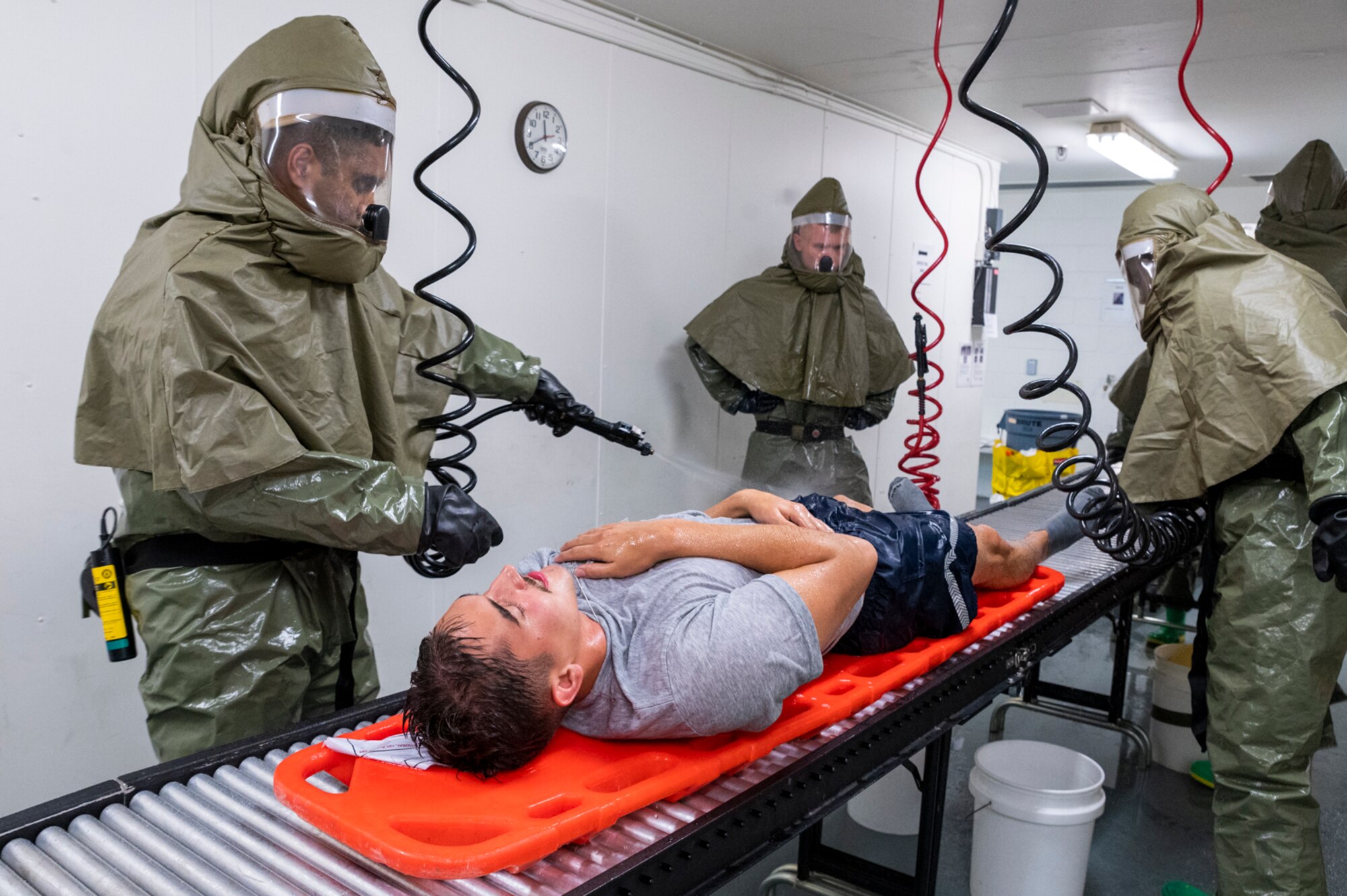 Airmen assigned to the 51st Medical Group decontaminate a simulated patient as part of a base-wide training event at Osan Air Base