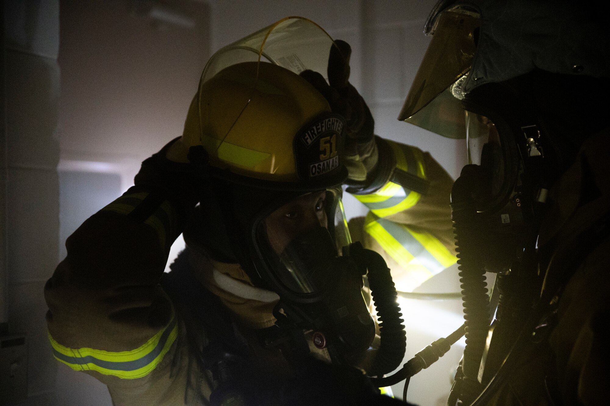 Firefighters from the 51st Civil Engineer Squadron conduct buddy checks during a fire response training event at Osan Air Base