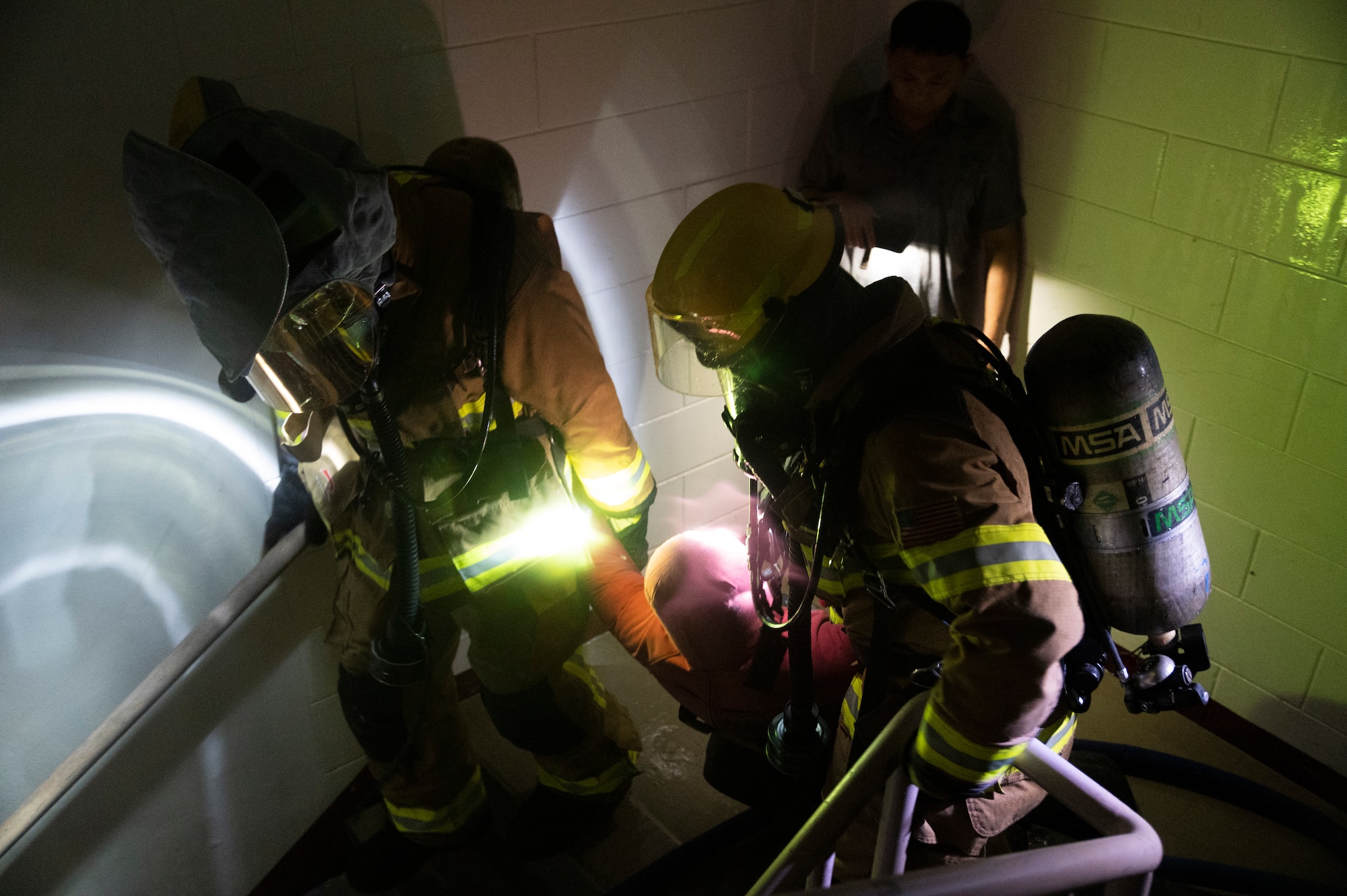 Firefighters from the 51st Civil Engineer Squadron carry out a mock victim during a fire response training event at Osan Air Base