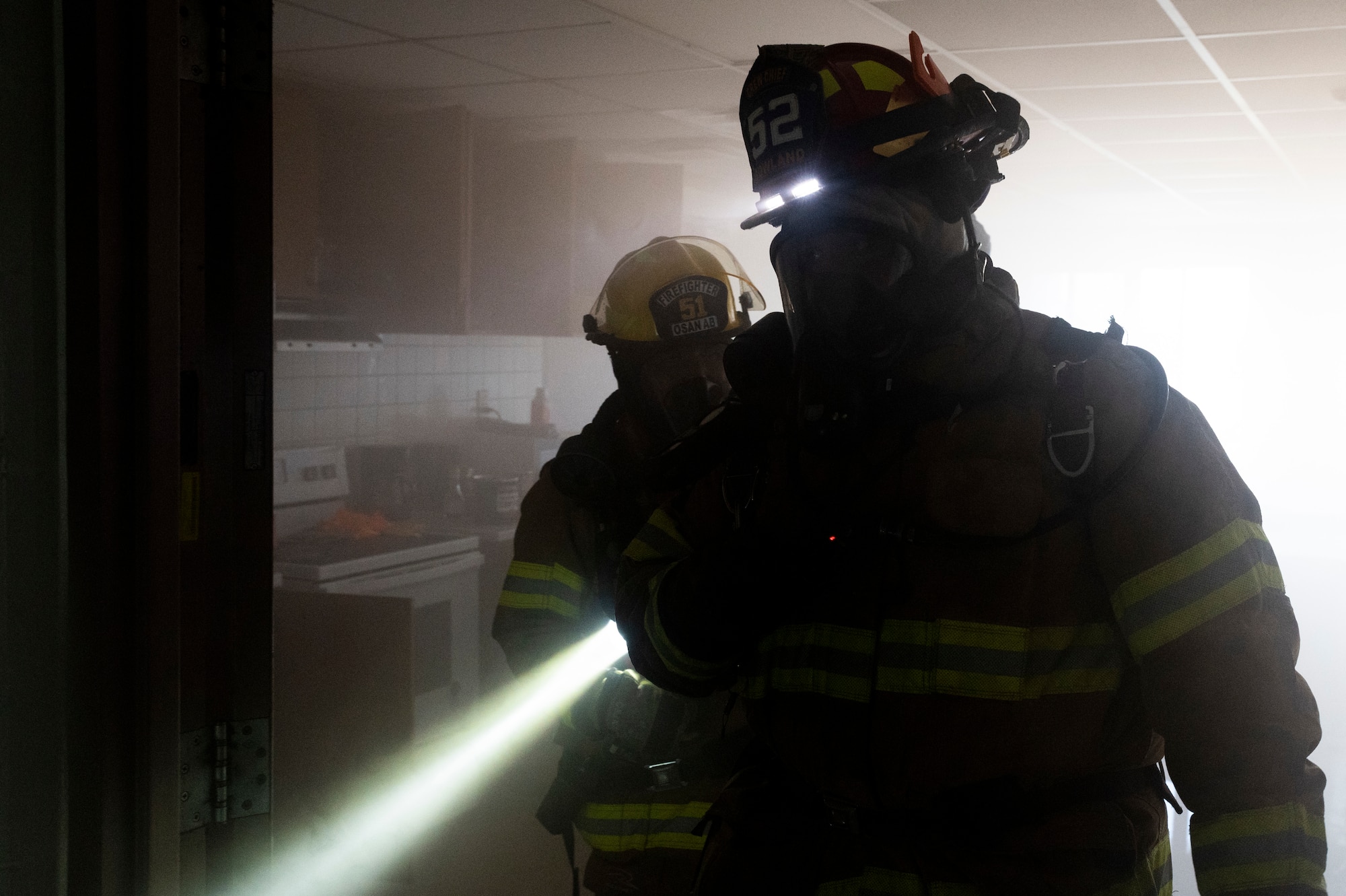 Firefighters from the 51st Civil Engineer Squadron inspect the scene of a simulated fire during a fire response training event at Osan Air Base