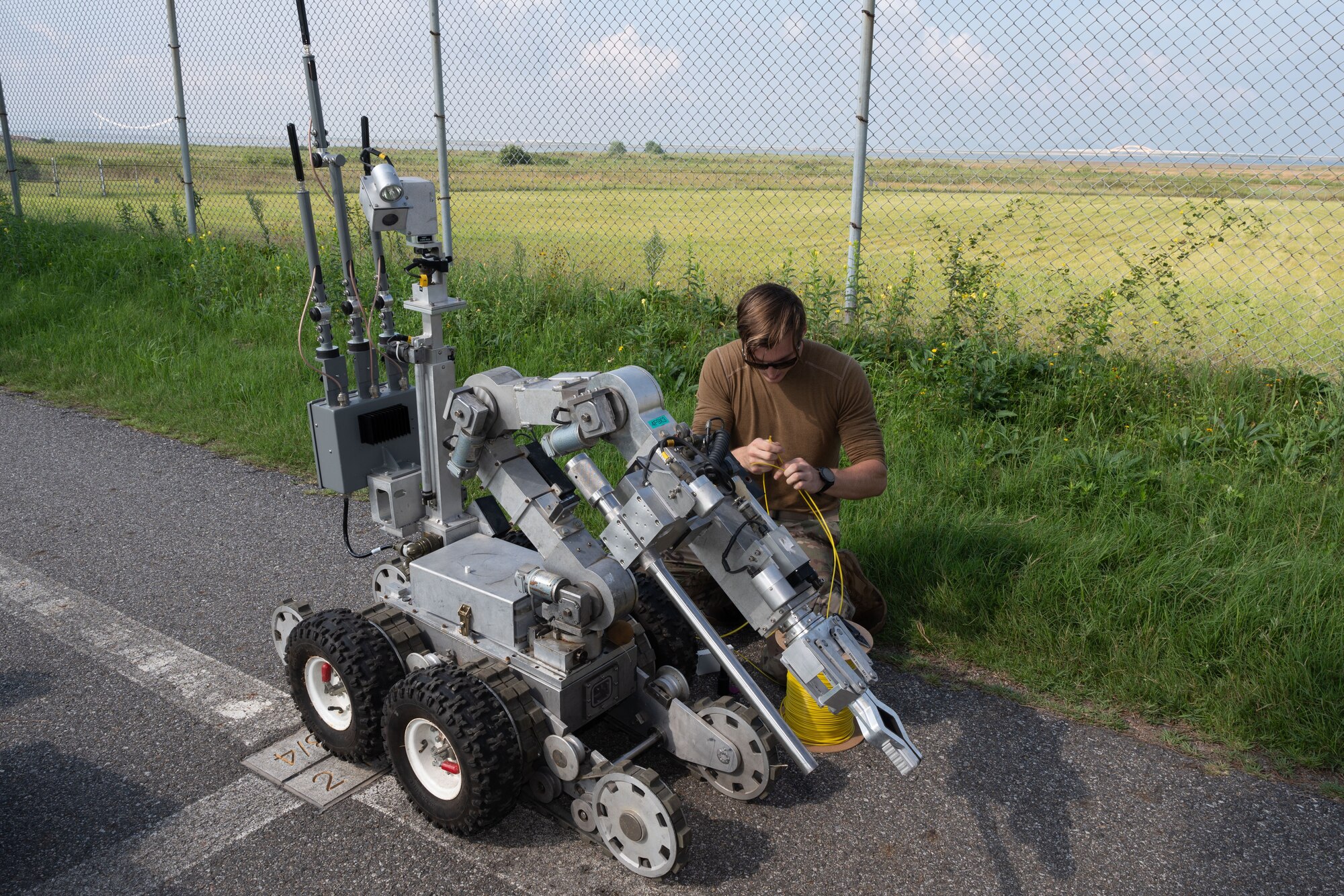 An Airman works on the F6 robot.