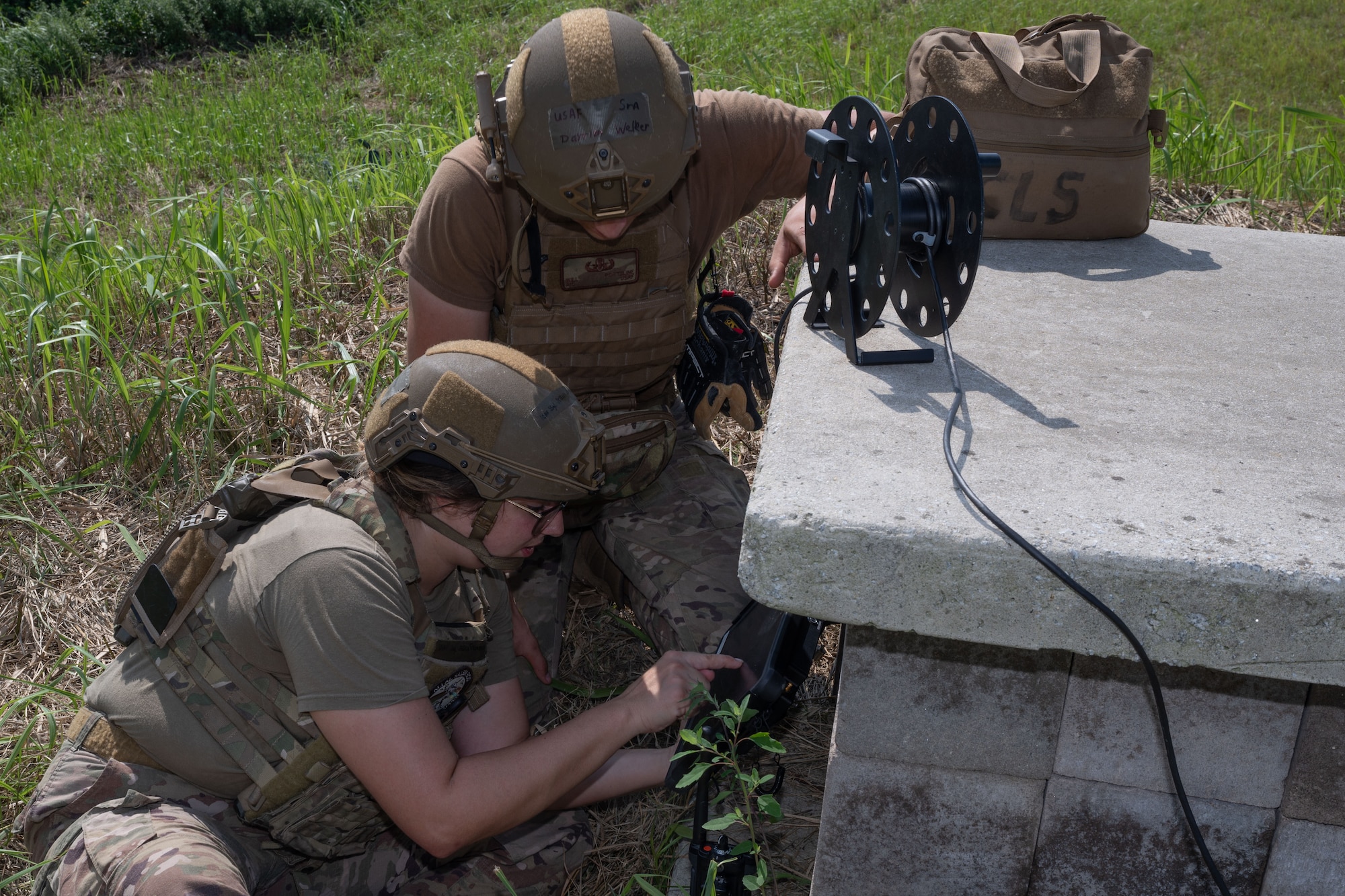 Two Airmen view an x-ray tablet.