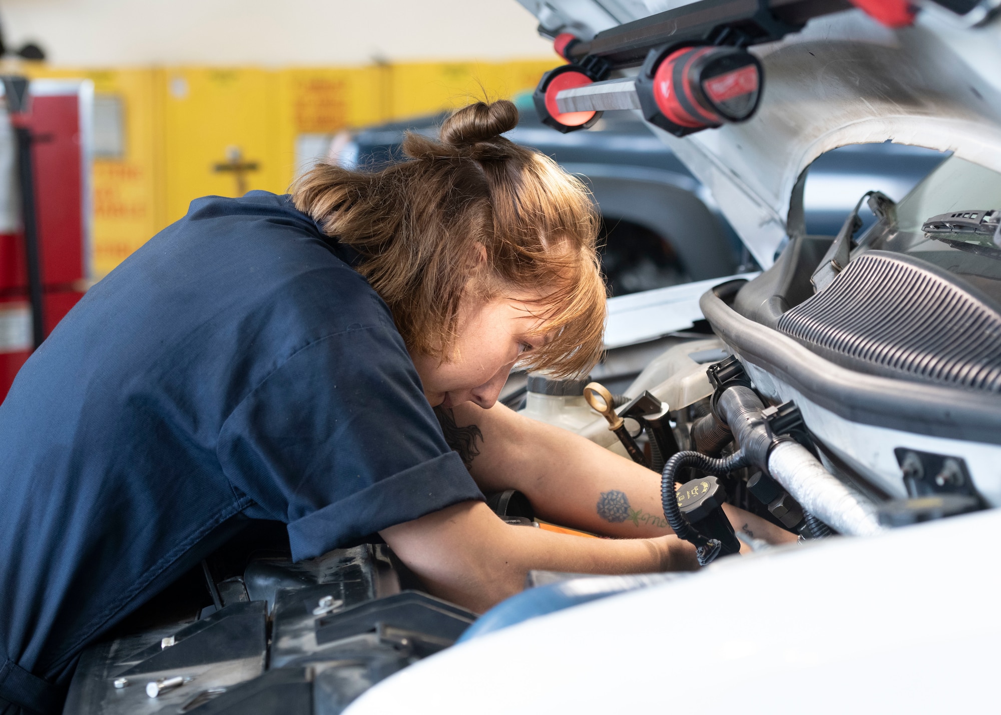 Airman 1st Class Maddison Stockman, 374th Logistics Readiness Squadron Vehicle Maintenance Flight apprentice, replaces an exhaust gas recirculation part on a government vehicle at Yokota Air Base, Japan, Aug. 17, 2022