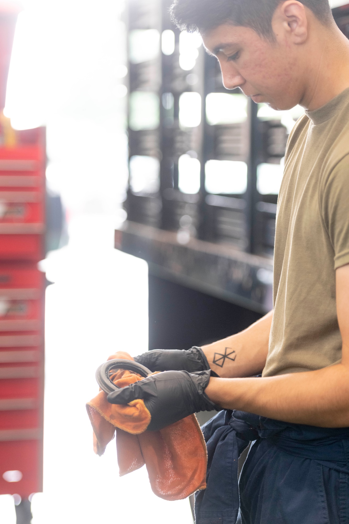 Airman 1st Class Deal Torre Joseph, 374th Logistics Readiness Squadron Vehicle Maintenance Flight apprentice, cleans a wheel bearing seal at Yokota Air Base, Japan, Aug. 17, 2022.