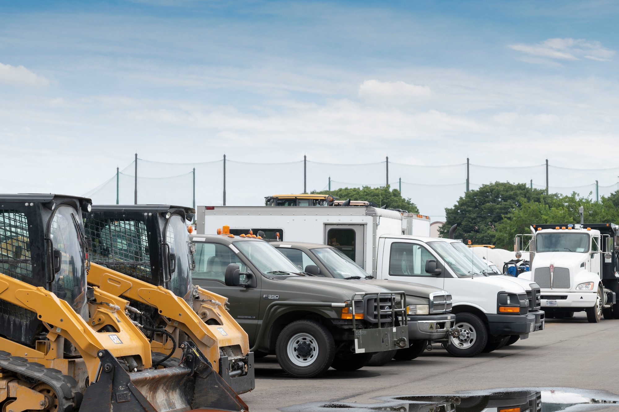 Government owned vehicles sit at the 374th Logistics Readiness Squadron Vehicle Maintenance Flight shop at Yokota Air Base, Japan, Aug. 17, 2022.
