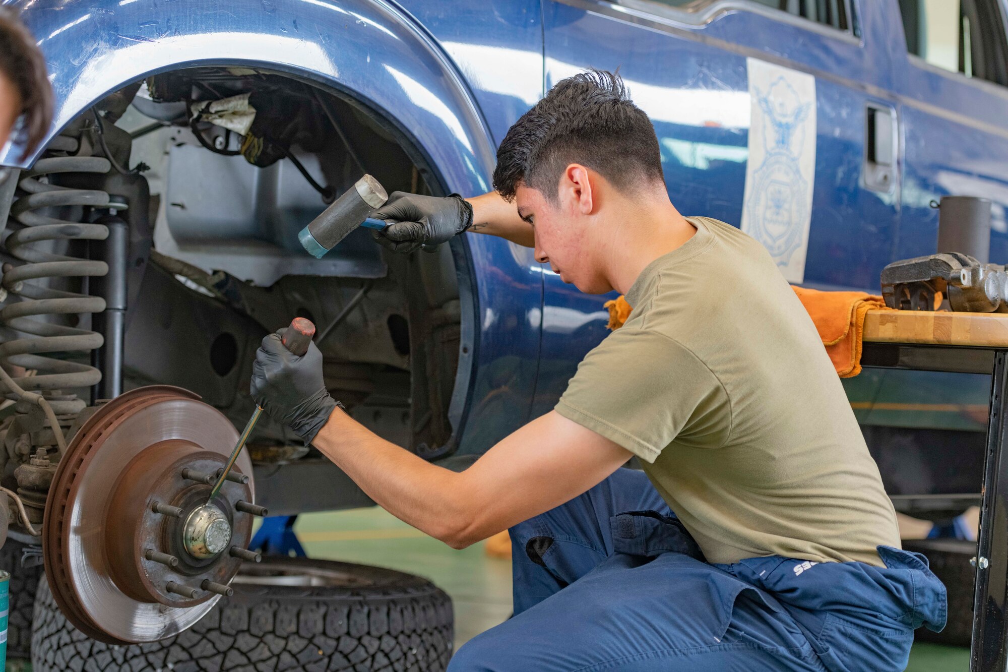 Airman 1st Class Deal Torre Joseph, 374th Logistics Readiness Squadron Vehicle Maintenance Flight apprentice, removes a brake rotor from a truck used by the 374th Security Forces Squadron at Yokota Air Base, Japan, Aug. 17, 2022.