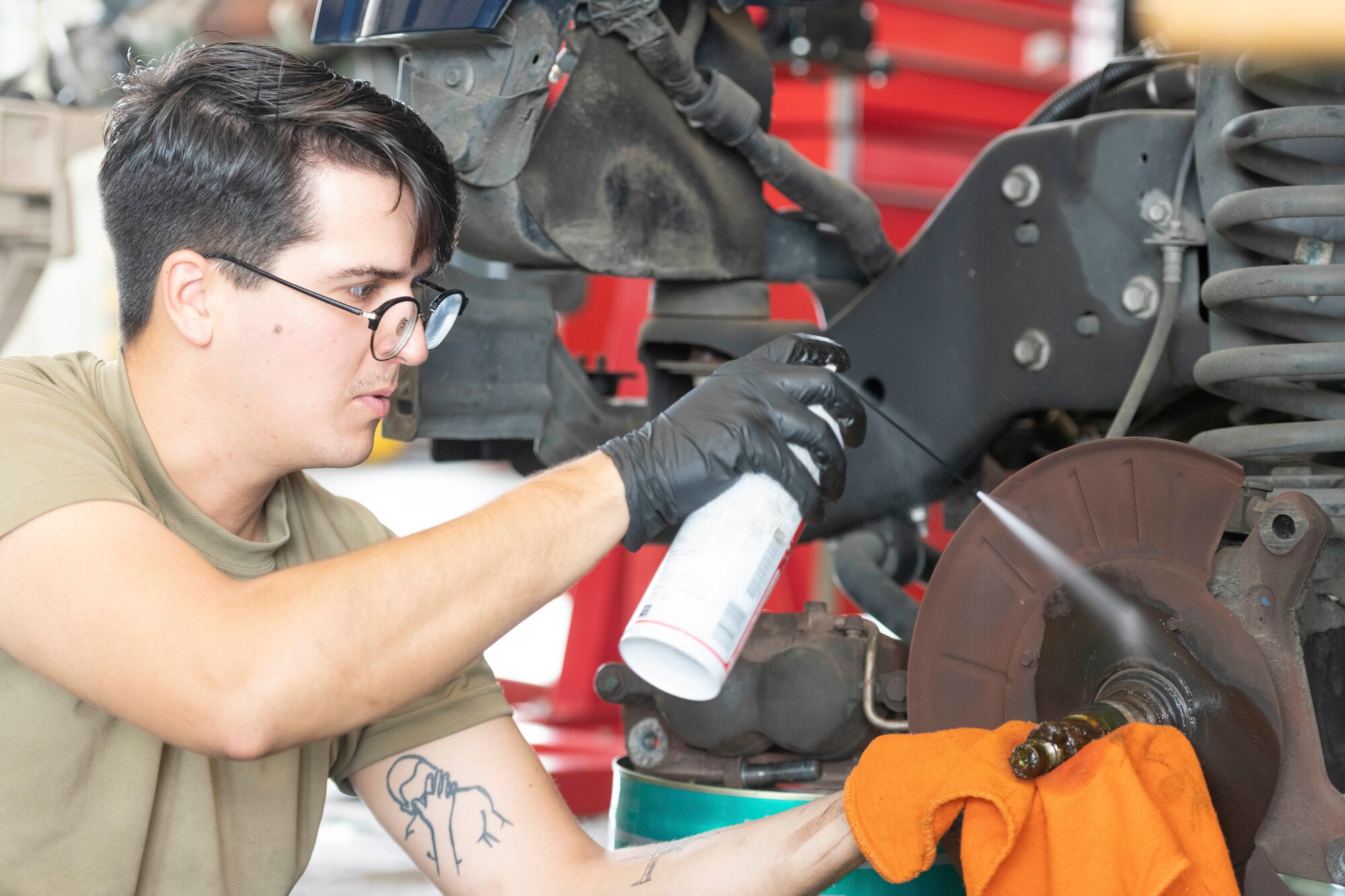 Senior Airman Michael Montero, 374th Logistics Readiness Squadron Vehicle Maintenance Flight journeyman, cleans a new brake rotor before installing at Yokota Air Base, Japan, Aug. 17, 2022.
