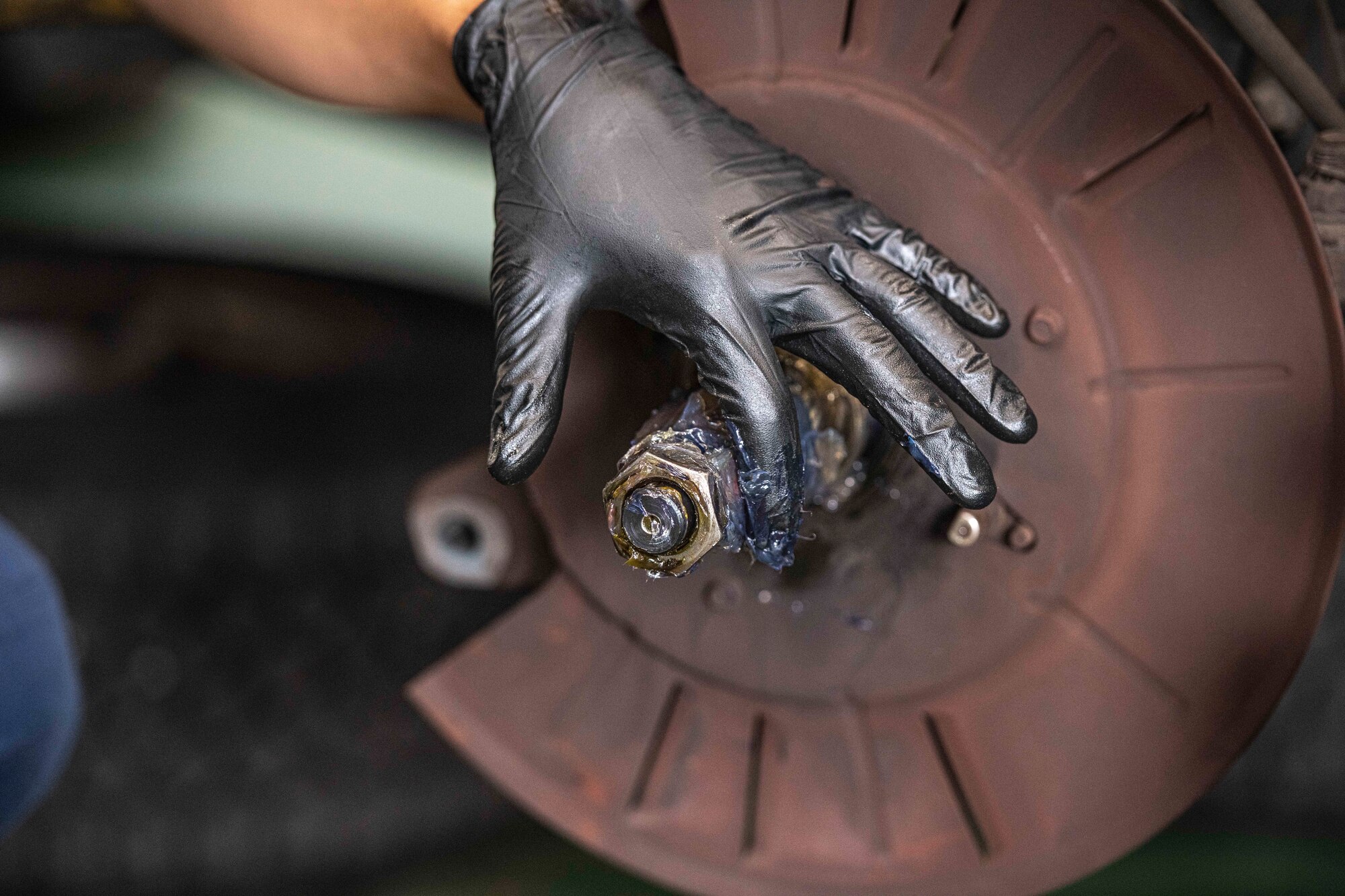 Airman 1st Class Deal Torre Joseph, 374th Logistics Readiness Squadron Vehicle Maintenance Flight apprentice, greases a bearing for brake assembly at Yokota Air Base, Japan, Aug. 17, 2022.