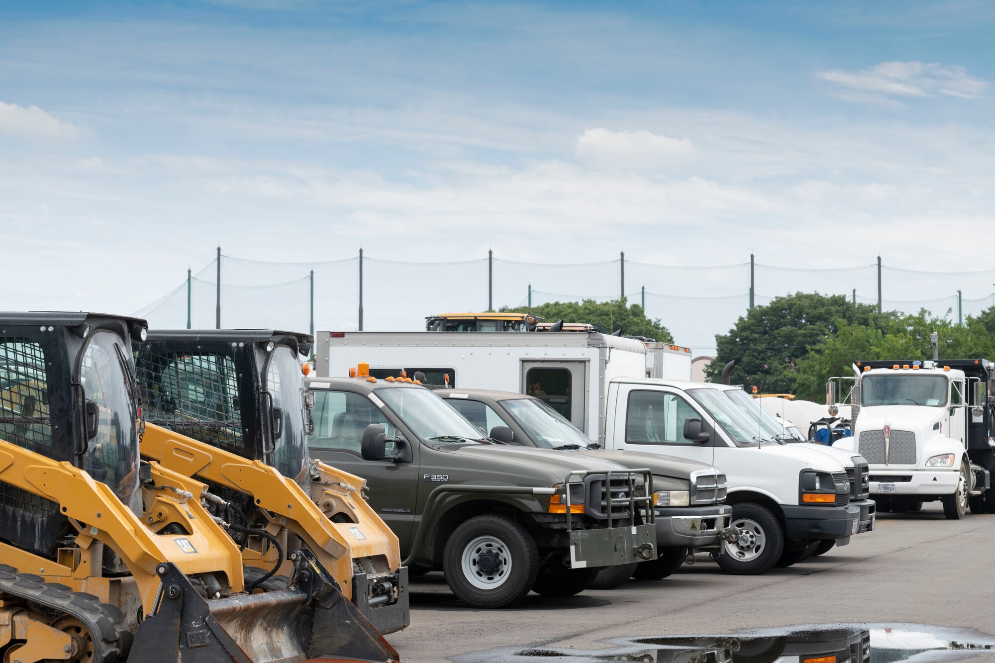 Government owned vehicles sit at the 374th Logistics Readiness Squadron Vehicle Maintenance Flight shop at Yokota Air Base, Japan, Aug. 17, 2022.