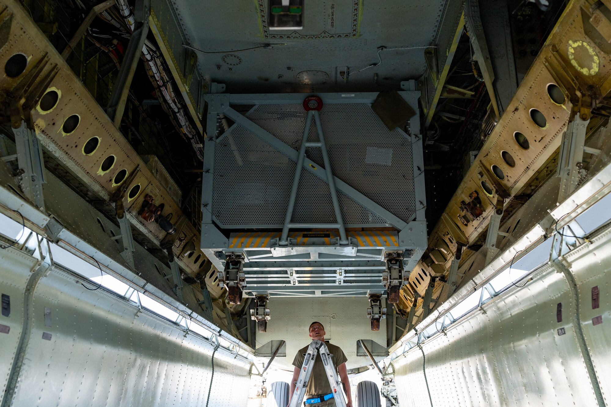 Senior Airman Aaron Wiles, 2nd Aircraft Maintenance Squadron engine mechanic, prepares to inspect a B-52 On-board Cargo System, known as BOCS, after landing at Fairchild Air Force Base, Washington, Aug. 18, 2022. The BOCS is a cargo container that connects to the operational bomb bays inside the aircraft and is capable of holding up to 5,000 pounds of maintenance and support equipment. (U.S. Air Force photo by Senior Airman Chase Sullivan)