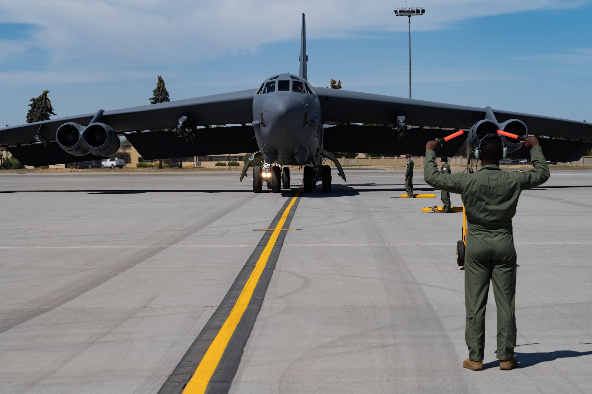 Master Sgt. Anthony Williams, 2nd Aircraft Maintenance Squadron production superintendent, marshals a B-52H Stratofortress on the flight line at Fairchild Air Force Base, Washington during an Agile Combat Employment exercise Aug. 16, 2022. The B-52 is a long-range, nuclear and conventional heavy bomber that can perform a variety of missions. (U.S. Air Force photo by Senior Airman Chase Sullivan)