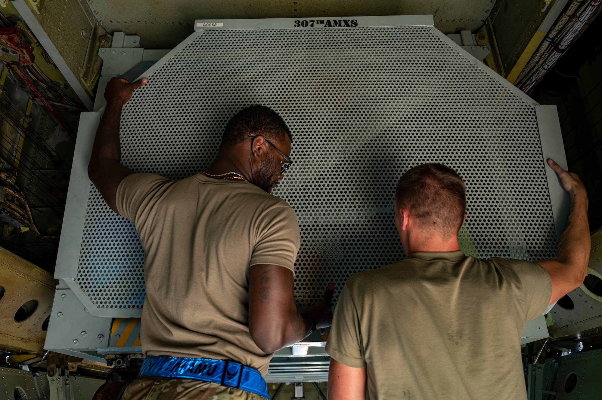 Master Sgt. Anthony Williams Jr., left, 2nd Aircraft Maintenance Squadron production supervisor, and Senior Airman Aaron Wiles, right, 2nd Aircraft Maintenance Squadron engine mechanic, remove the outer wall of an On-board Cargo System inside a B-52H Stratofortress during an Agile Combat Employment exercise at Fairchild Air Force Base, Washington, Aug. 18, 2022. Each B-52 can house two BOCSs each loaded with up to 5,000 lbs of maintenance and support equipment. (U.S. Air Force photo by Senior Airman Chase Sullivan)