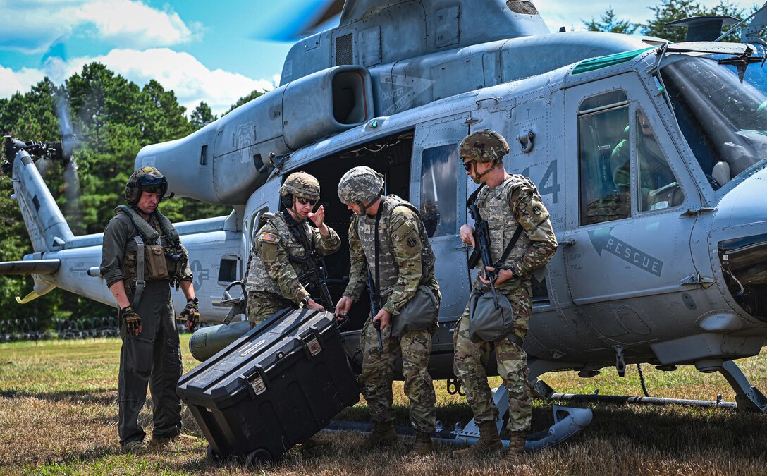 U.S. Army Soldiers assigned to the U.S. Army Reserve, 78th Training Division, upload a crate of mail onto a UH-60 during Exercise Postal Warrior 2022 at Joint Base McGuire-Dix-Lakehurst, N.J. on 10 Aug, 2022. Postal Warrior 2022 is a standalone, task-focused exercise, designed to train and challenge postal units in the skill sets and competencies needed to support Theater Postal Operations and increase individual and collective readiness. Approximately 600 soldiers participated in the exercise, which included both classroom and simulated field training at the Army Support Activity Fort Dix Ranges. (U.S. Air Force photo by Staff Sgt. Sabatino Dimascio)